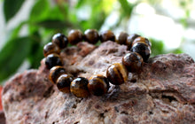 Load image into Gallery viewer, Tiger eye bracelet. High quality 12mm faceted beads.Unisex bracelet. Gift for her and him.
