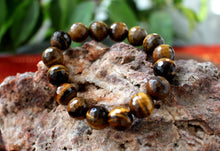 Load image into Gallery viewer, Tiger eye bracelet. High quality 12mm faceted beads.Unisex bracelet. Gift for her and him.
