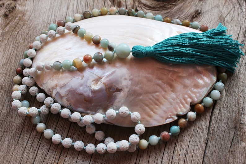 108 beads lovingly hand-knotted mala. Made of white Lava stone, Amazonite and Love.