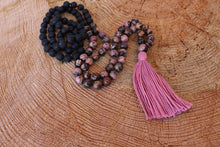 Load image into Gallery viewer, Pink Black Rhodonite and Lava Stone Mala. Hand knotted 108 beads Mala, Handmade Cotton Tassel. Vegan necklace .
