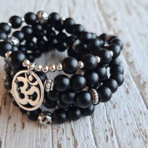 Matte Onyx Om Mala stretch mala with artisan om charm, black onyx wrap bracelet.